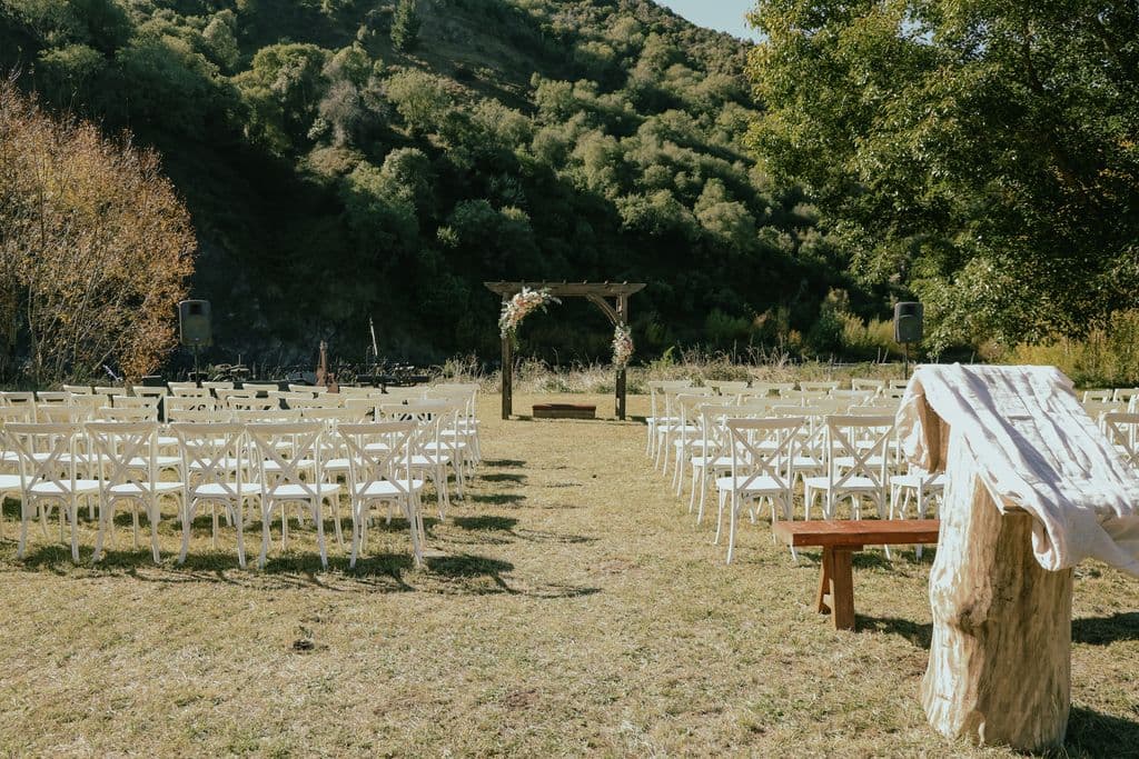 Guests enjoying an outdoor wedding with river views and farm landscapes