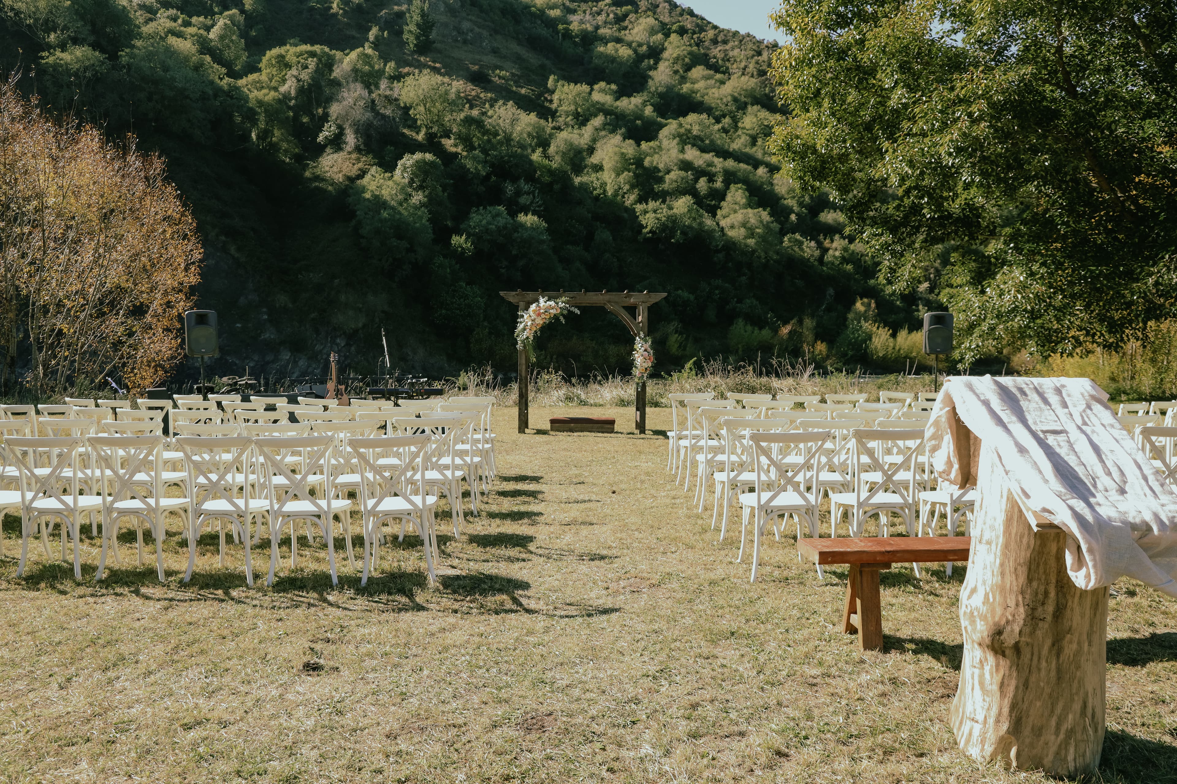Guests enjoying an outdoor wedding with river views and farm landscapes