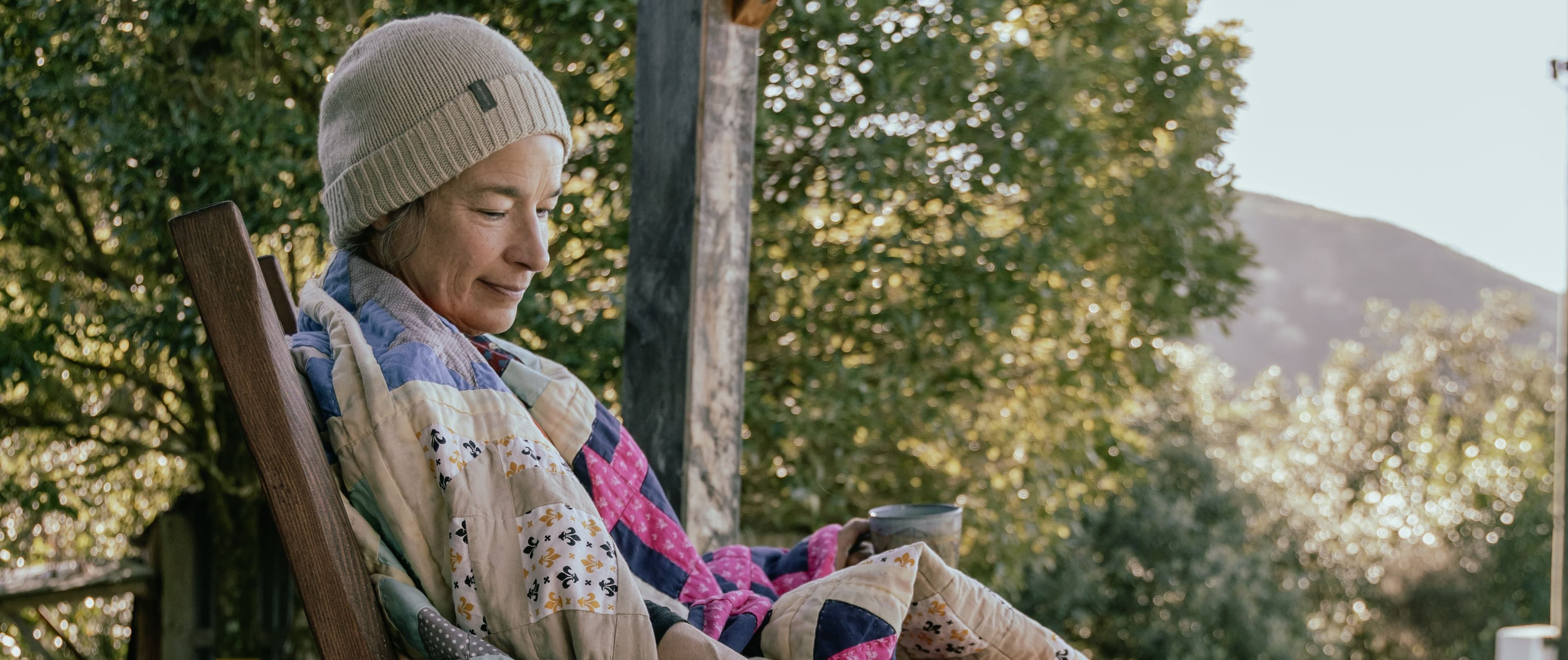 Mid-life reflection with quilts and furniture adding warmth to a modest home