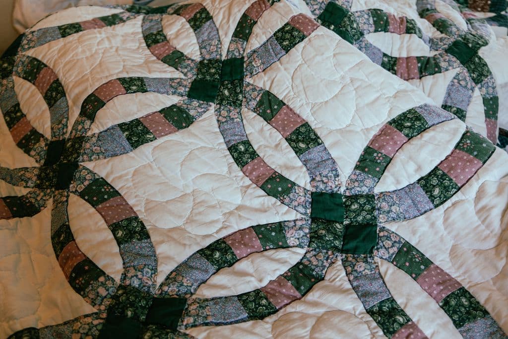 Close-up of traditional quilt stitching showing interlocking rings pattern for marriage