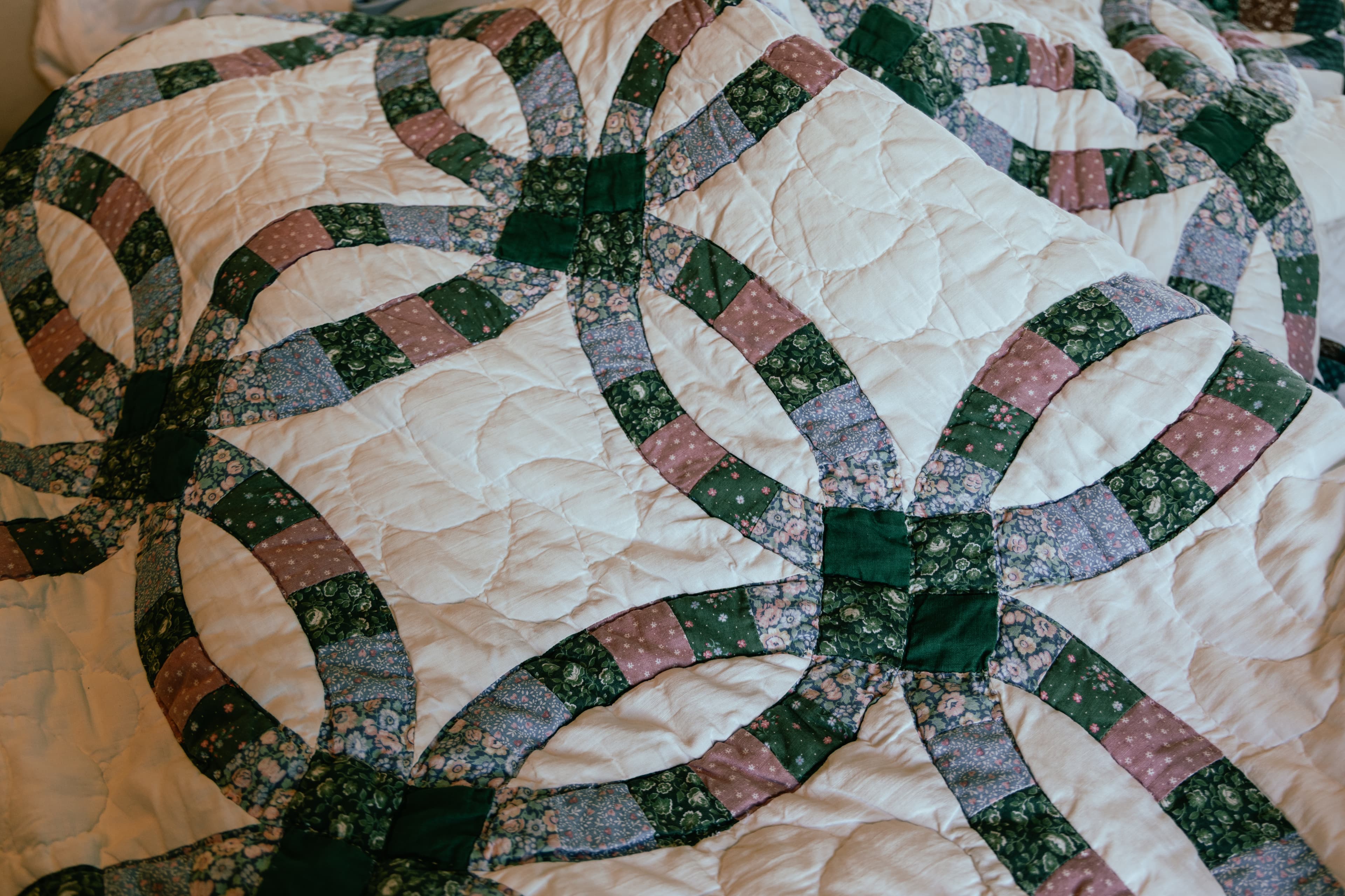 Close-up of traditional quilt stitching showing interlocking rings pattern for marriage