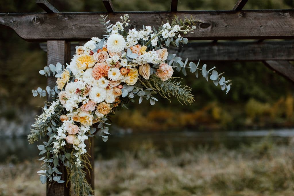 A gorgeous handmade timber wedding arch decorated with a beautiful flower arrangement. This was for an outdoor wedding held at Mohaka River Farm, May 2026
