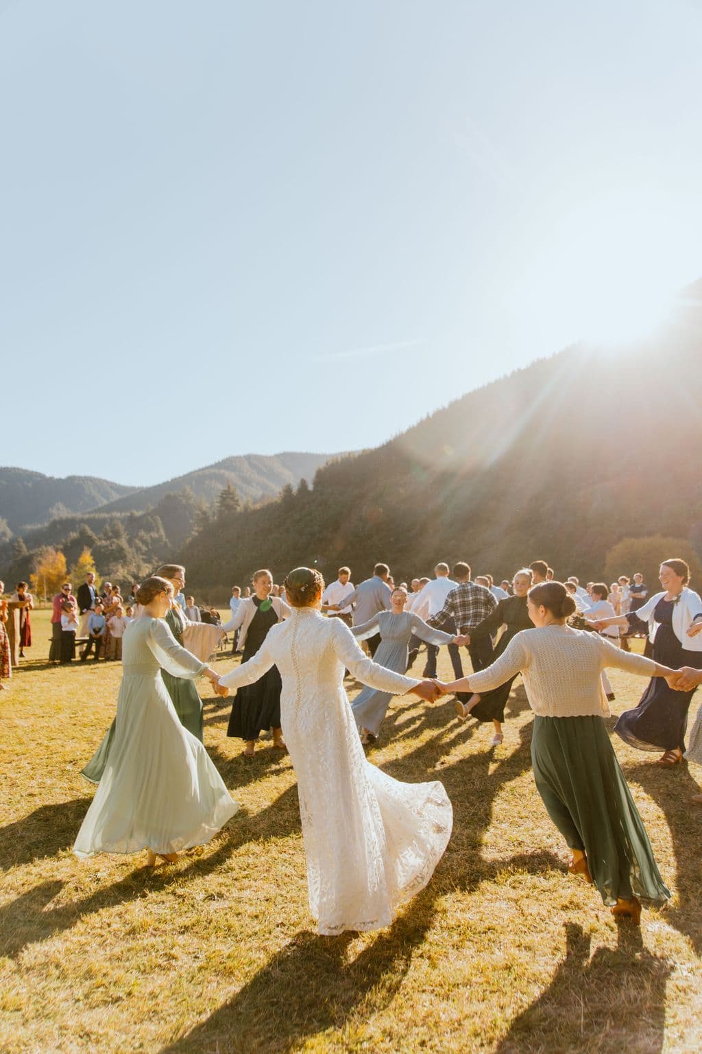Weddings attendees dance in the sunlight having a great time as part of the outdoor wedding celebrations. Mohaka River Farm, 2026