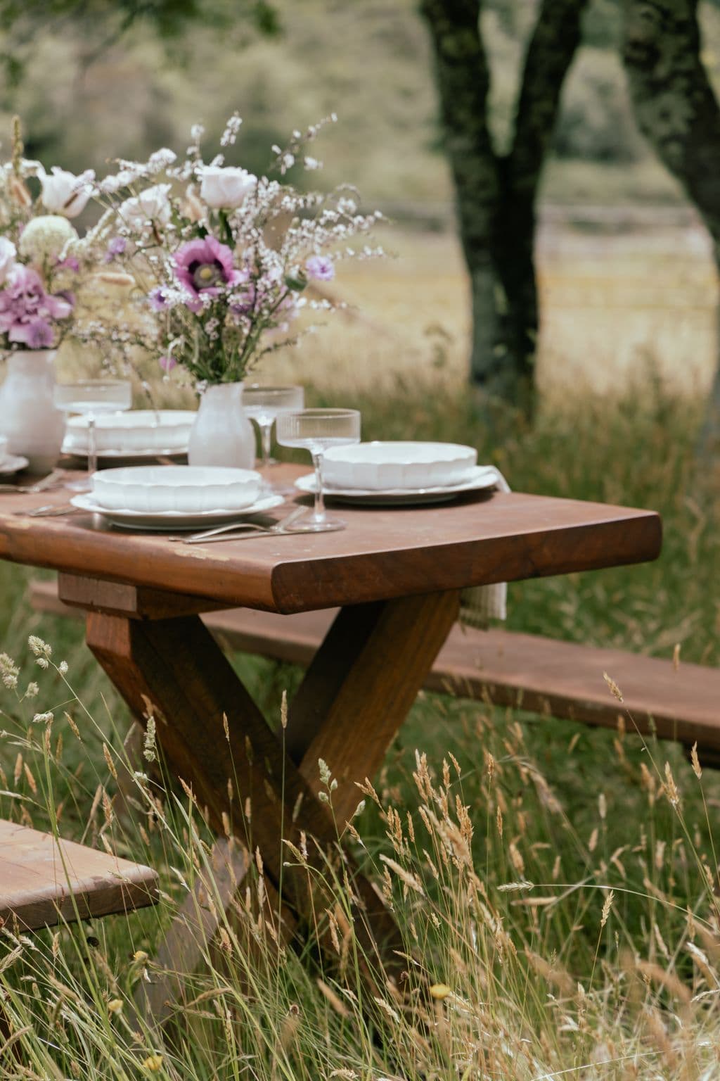 A beautifully set and decorated table for outdoor dining as part of a destination wedding at Mohaka River Farm in Hawke's Bay near Taupo