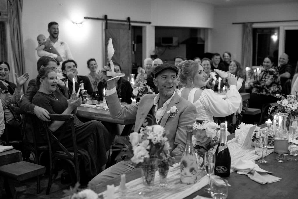 Wedding attendees smiling and laughing at the indoor reception area for a wedding at Mohaka River Farm in Hawke's Bay, 2025